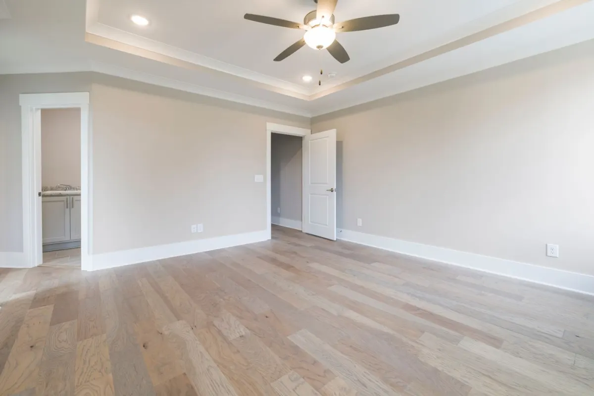 A ceiling fan with a lit center fixture in a bright room